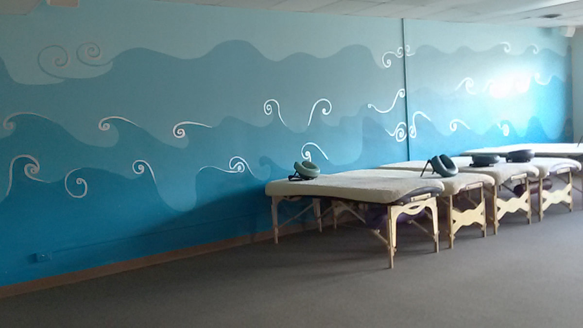 Wall of Painted Blue Waves and some massage tables